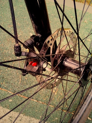 Dynamic shot of an electric bike wheel spinning fast, highlighting the green brake calipers
