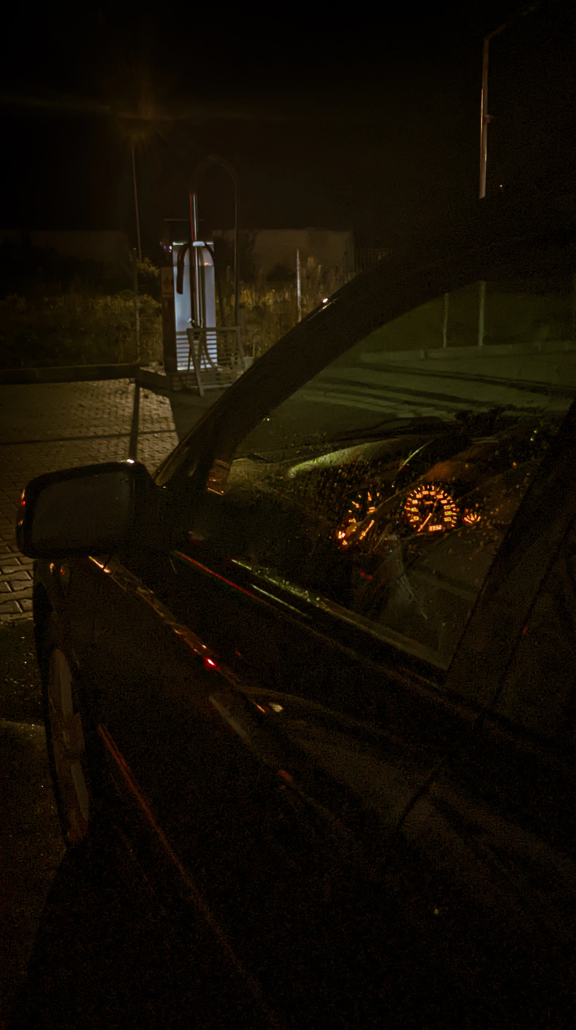 a car parked on the side of the road at night