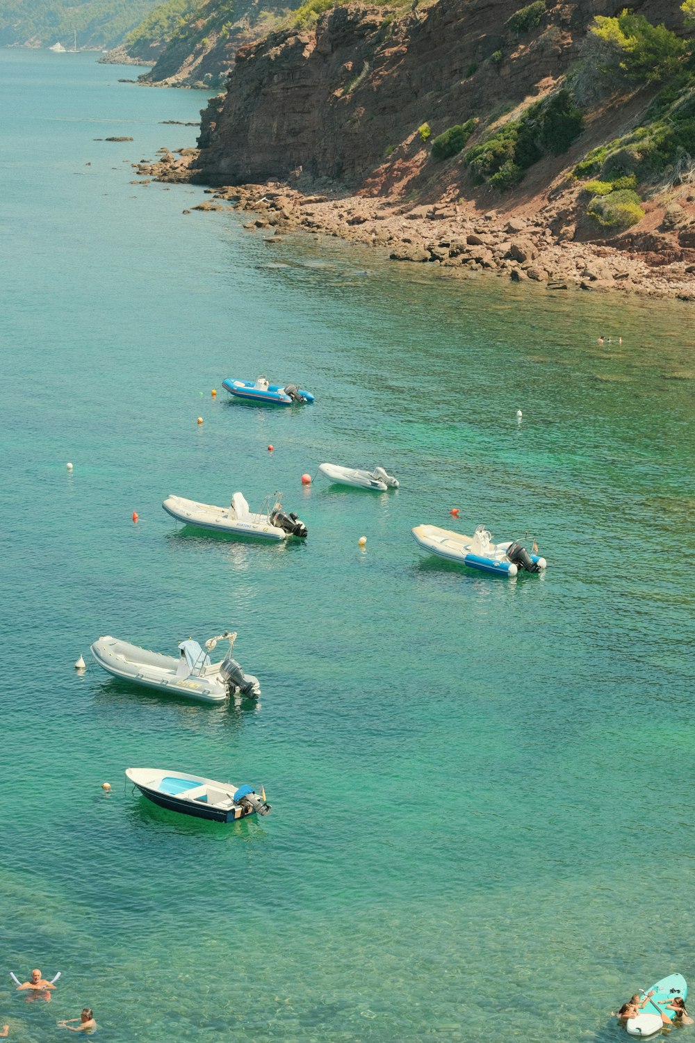 a group of boats floating on top of a body of water