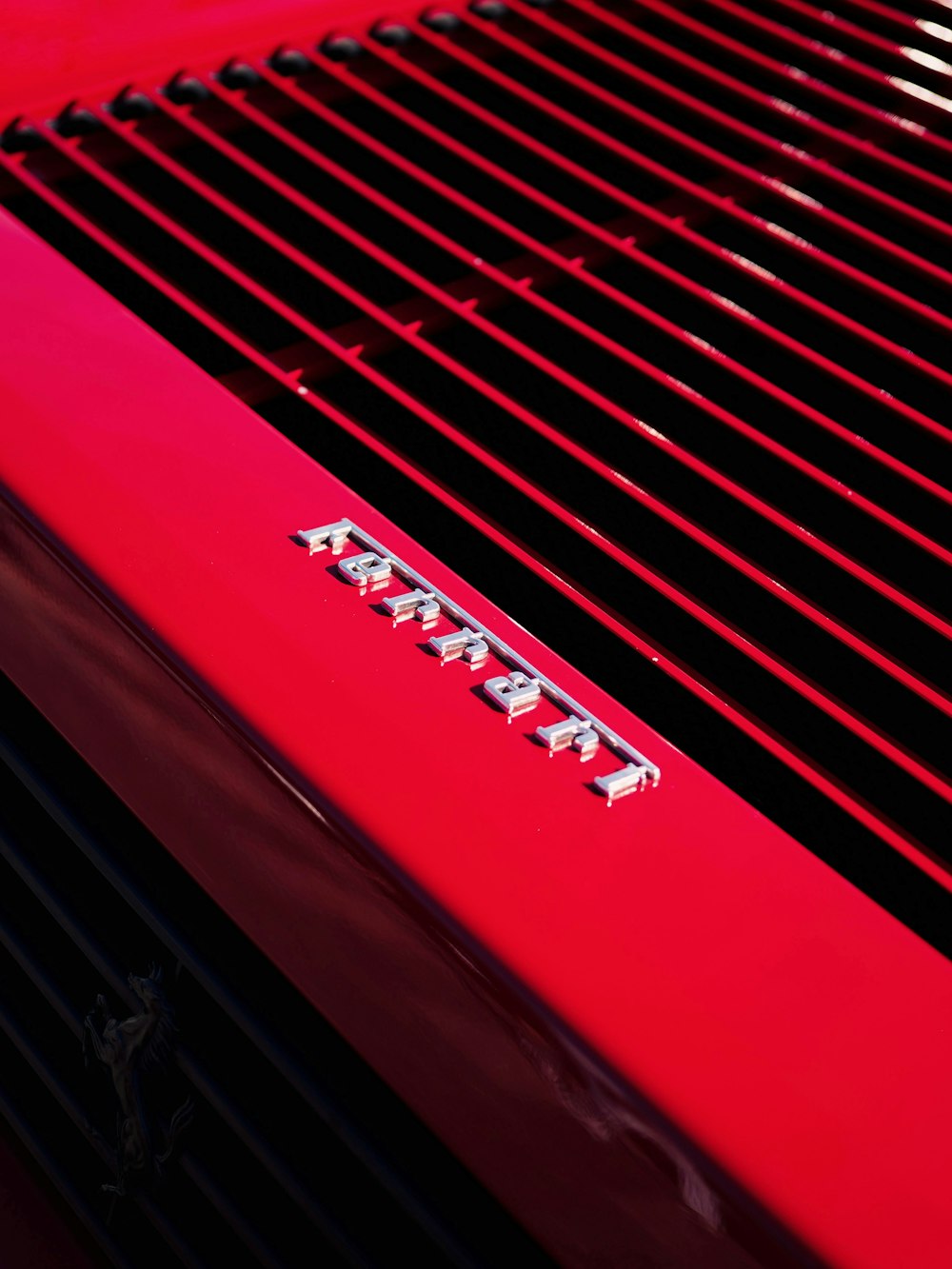 a close up of a red grill on a car
