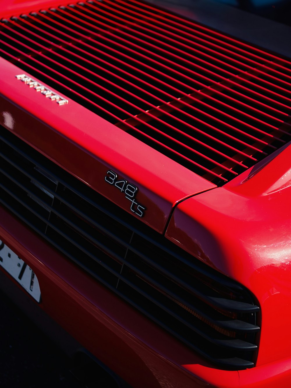 a close up of the front of a red sports car