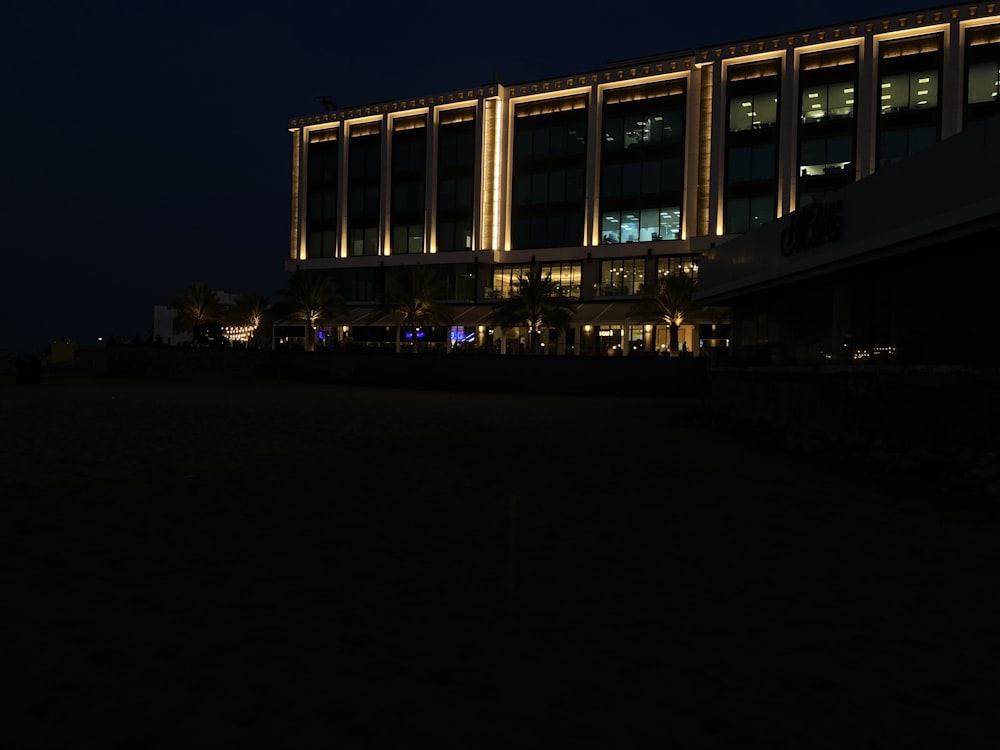 a large building lit up at night with lights on