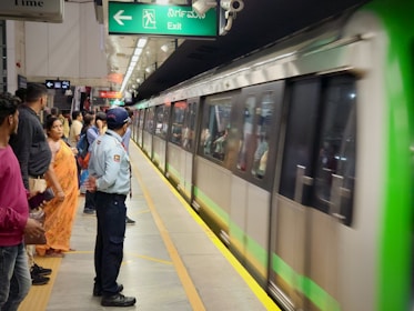 A serene metro station with people boarding trains calmly.