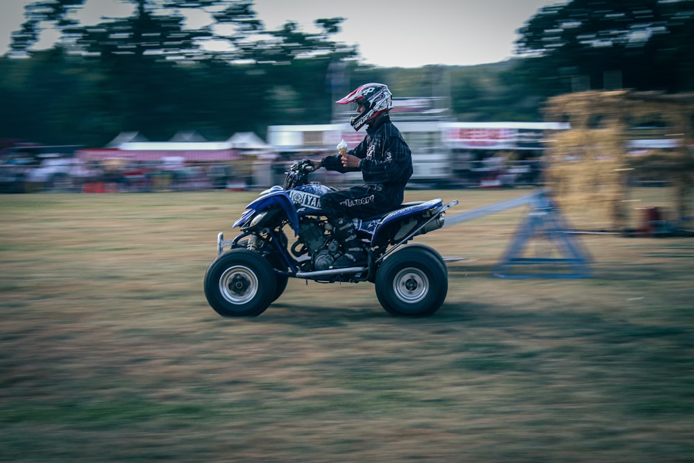 a person riding a four wheeler in a field