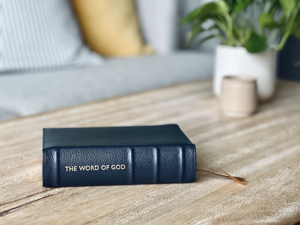 a blue book sitting on top of a wooden table