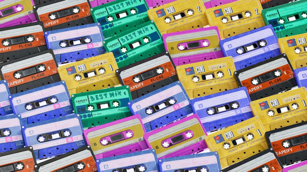 a pile of colorful cassette tapes sitting on top of each other