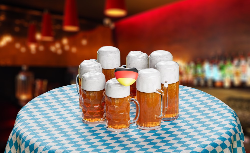 a group of beer mugs sitting on top of a table