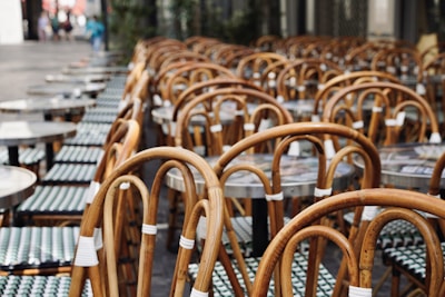 Row of simple chairs outside a small café on a quiet street corner.