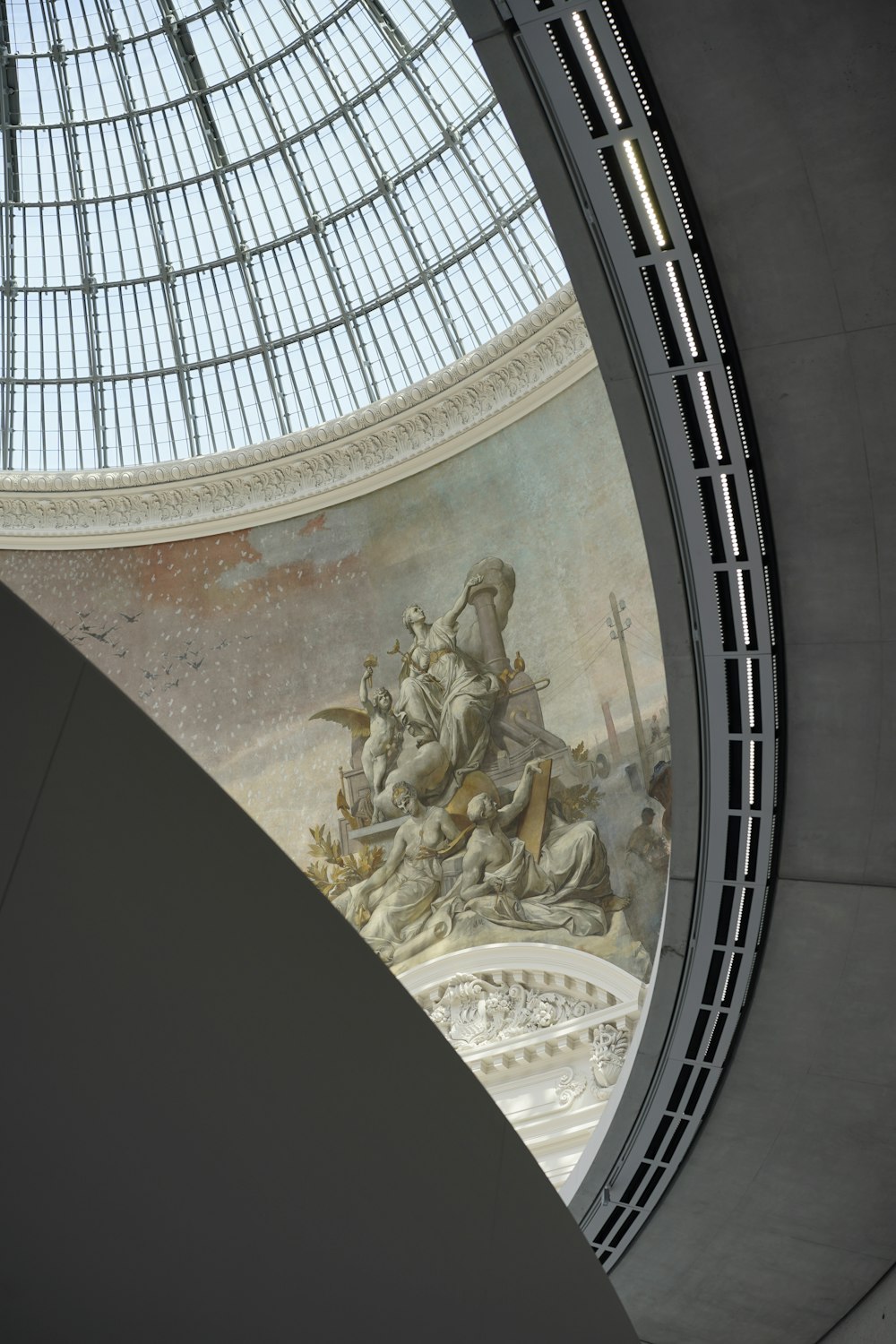 the ceiling of a building with a painting on it