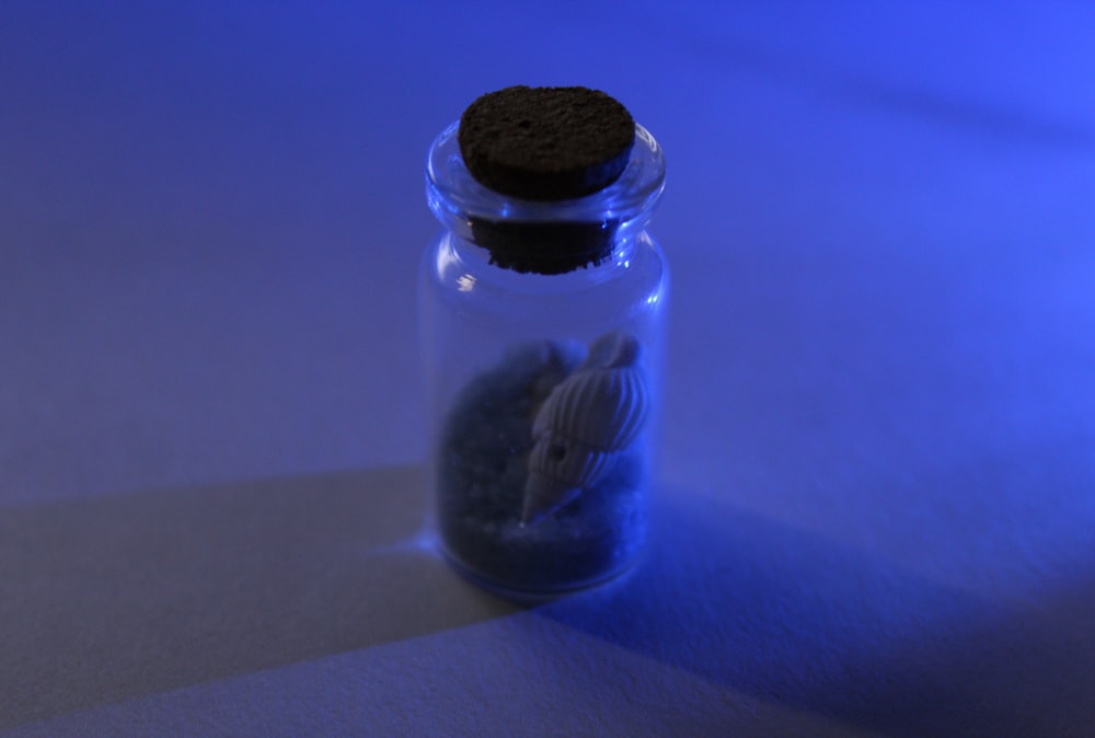 a cookie sitting on top of a glass jar