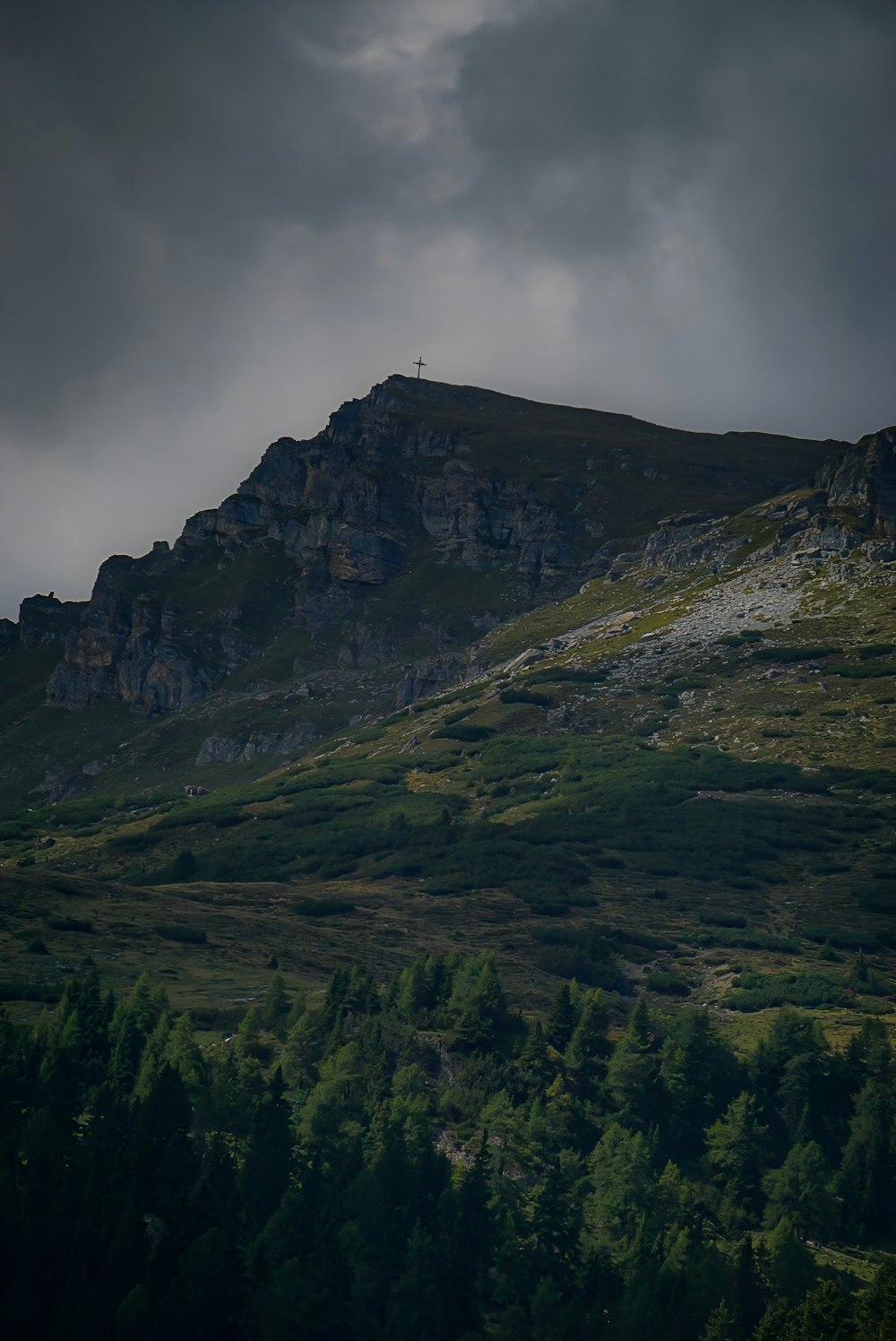 a hill with a cross on top of it