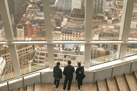 A team of professionals reviewing investment portfolios in a modern office with city views.