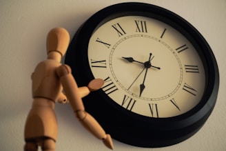a wooden toy standing next to a clock