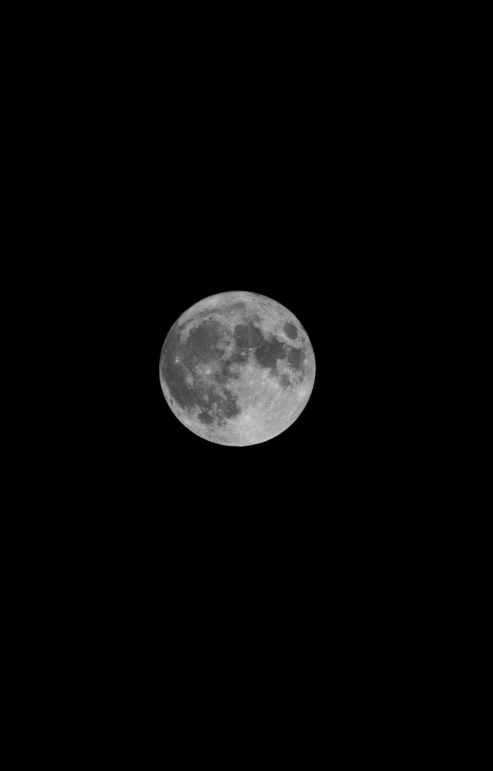 a full moon is seen in the night sky