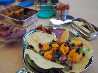 Close-up of a colorful plate of chiles en nogada with pomegranate seeds.