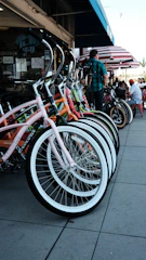 A row of well-maintained bikes parked outside a vibrant local shop in Varanasi.