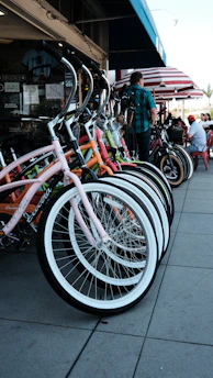 A row of well-maintained bikes parked outside a vibrant local shop in Varanasi.
