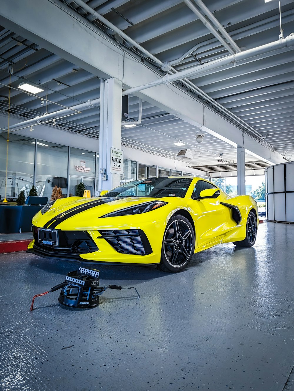 a yellow sports car parked in a garage