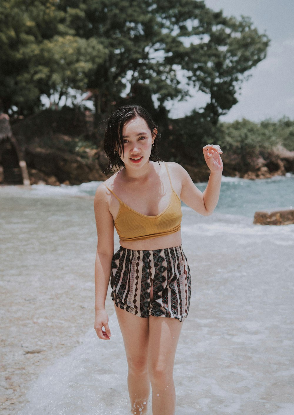 a woman standing in the water at the beach