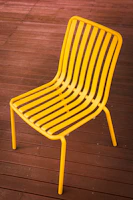 Synthetic fiber chair with waterproof fabric on a wooden deck during golden hour