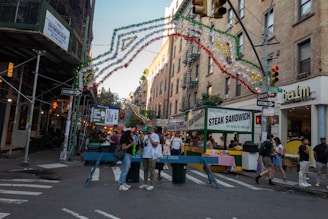 A lively Sicilian street scene with local food vendors and vibrant decorations