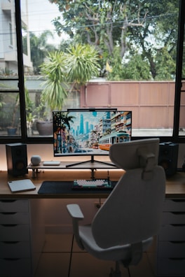 Modern curved computer monitor displaying vibrant graphics in a cozy home office.