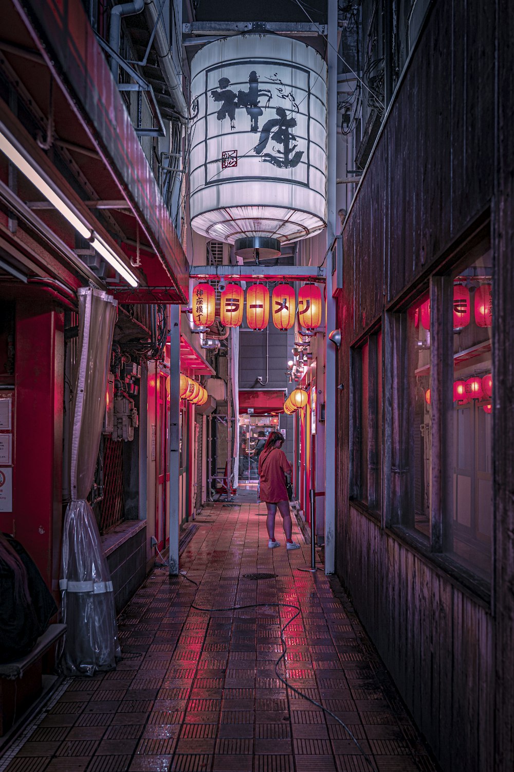 a person walking down a long narrow alley way