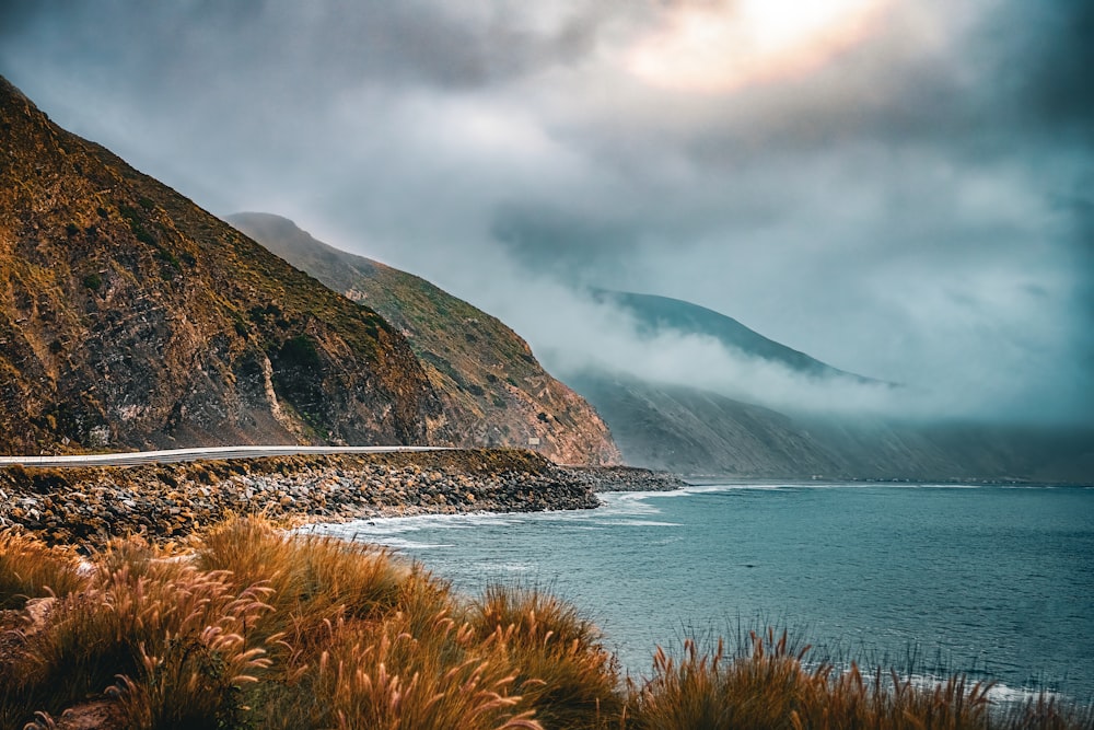 a scenic view of the ocean and mountains