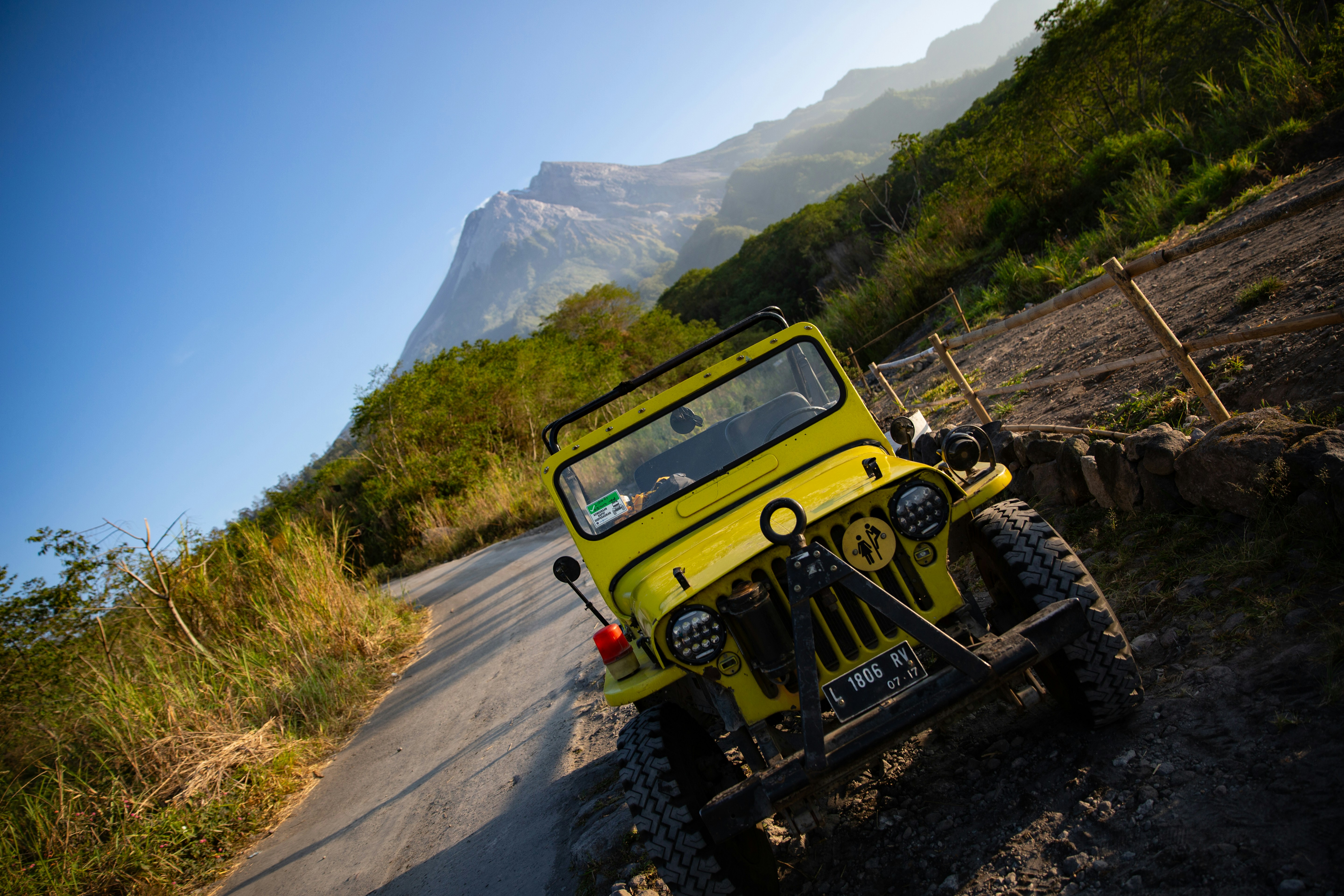 a yellow jeep is parked on the side of the road
