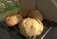 Close-up of freshly baked bread loaves cooling on a wooden rack in a bakery.
