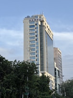 Exterior view of the Dhaka unit factory building on R. K. Nandi Lane under bright daylight.