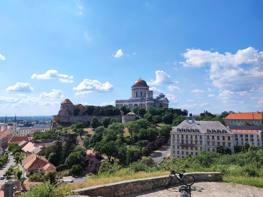 a bike is parked on a ledge overlooking a city