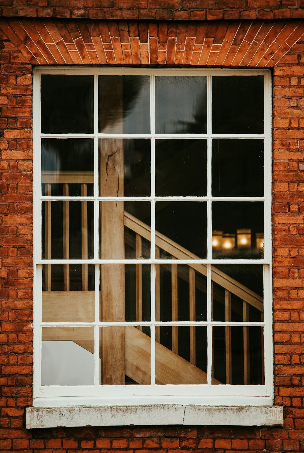 a brick wall with a window and a stair case