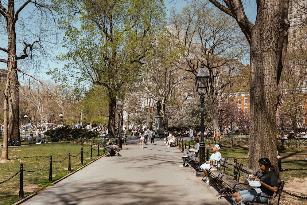 a group of people sitting on top of a park bench