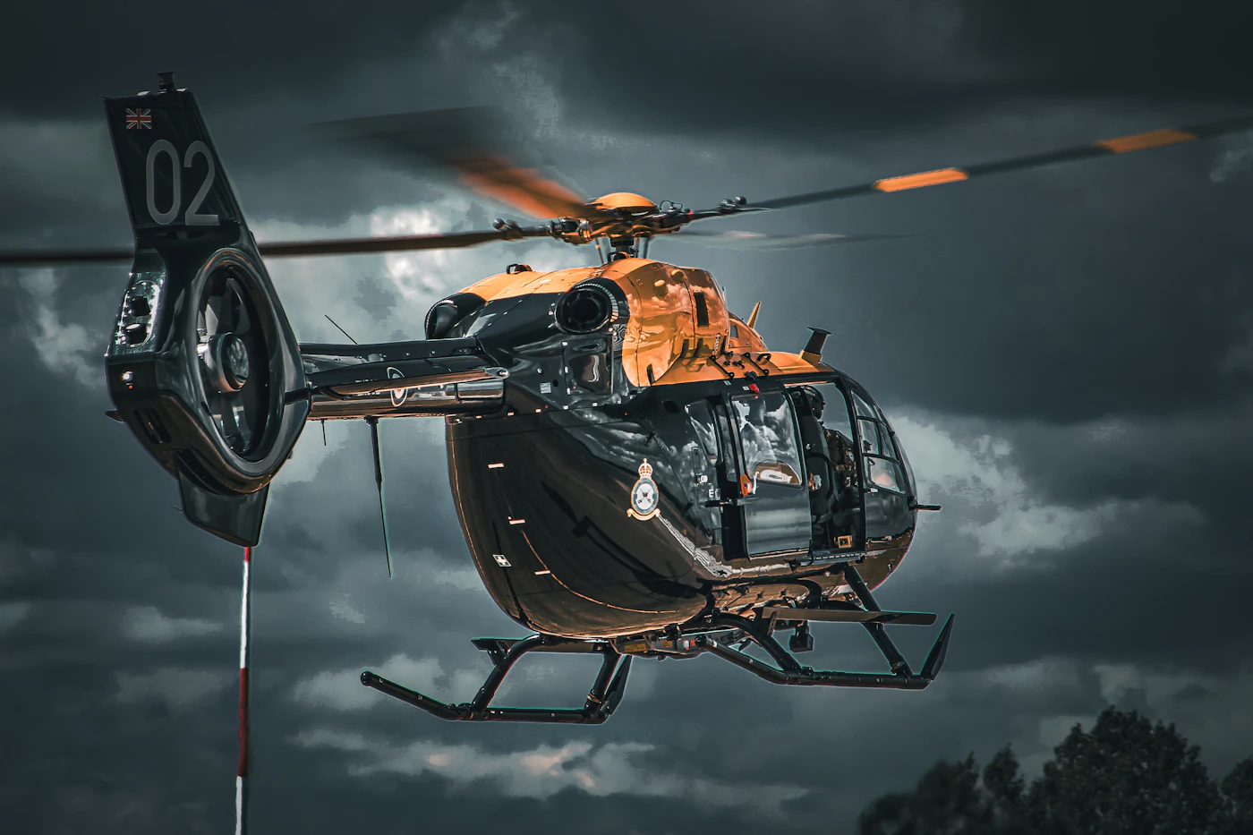 Transport helicopter flying through a cloudy sky, the kind of conditions offshore crews face on platform runs