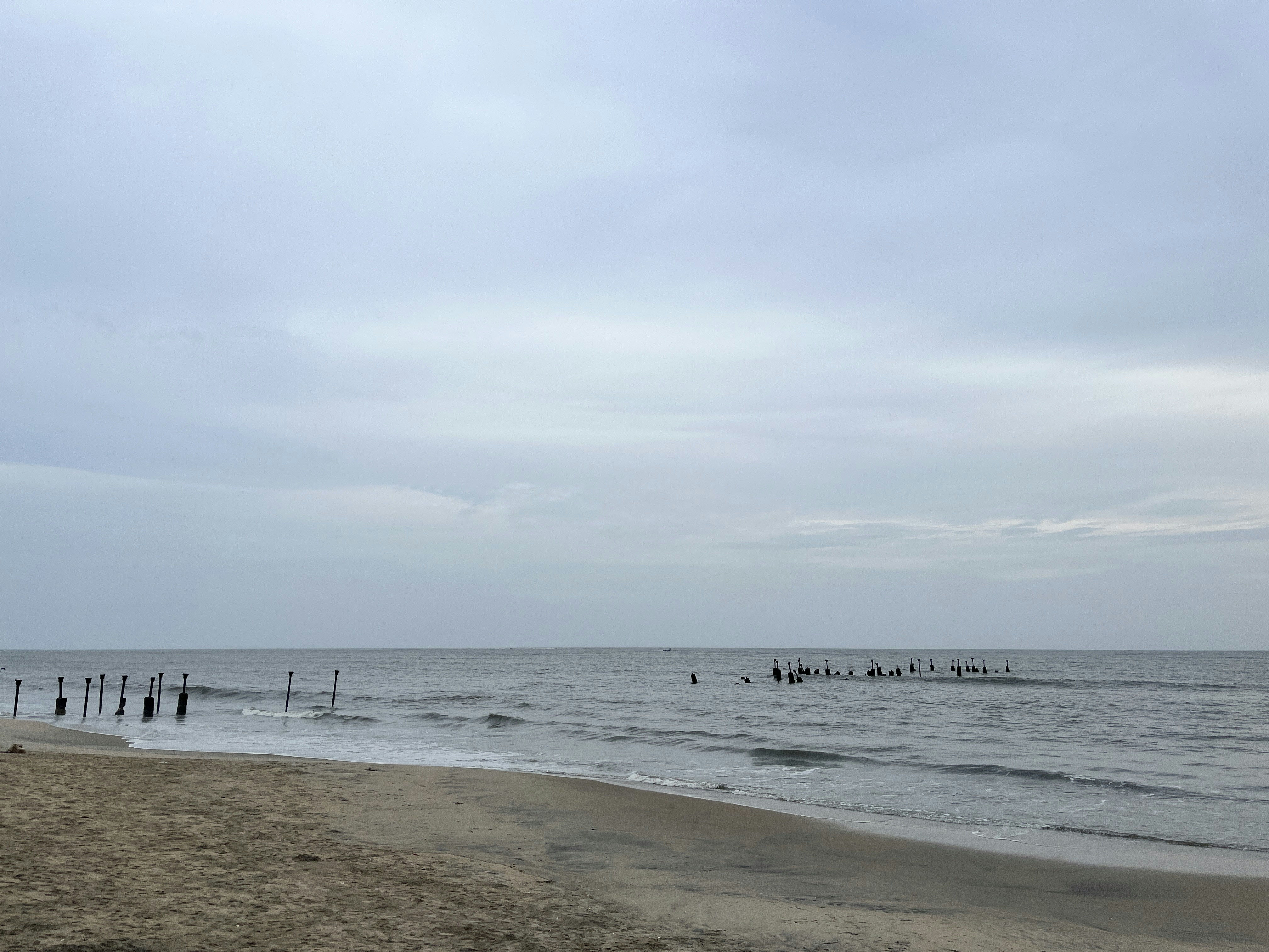 a group of people standing on top of a sandy beach