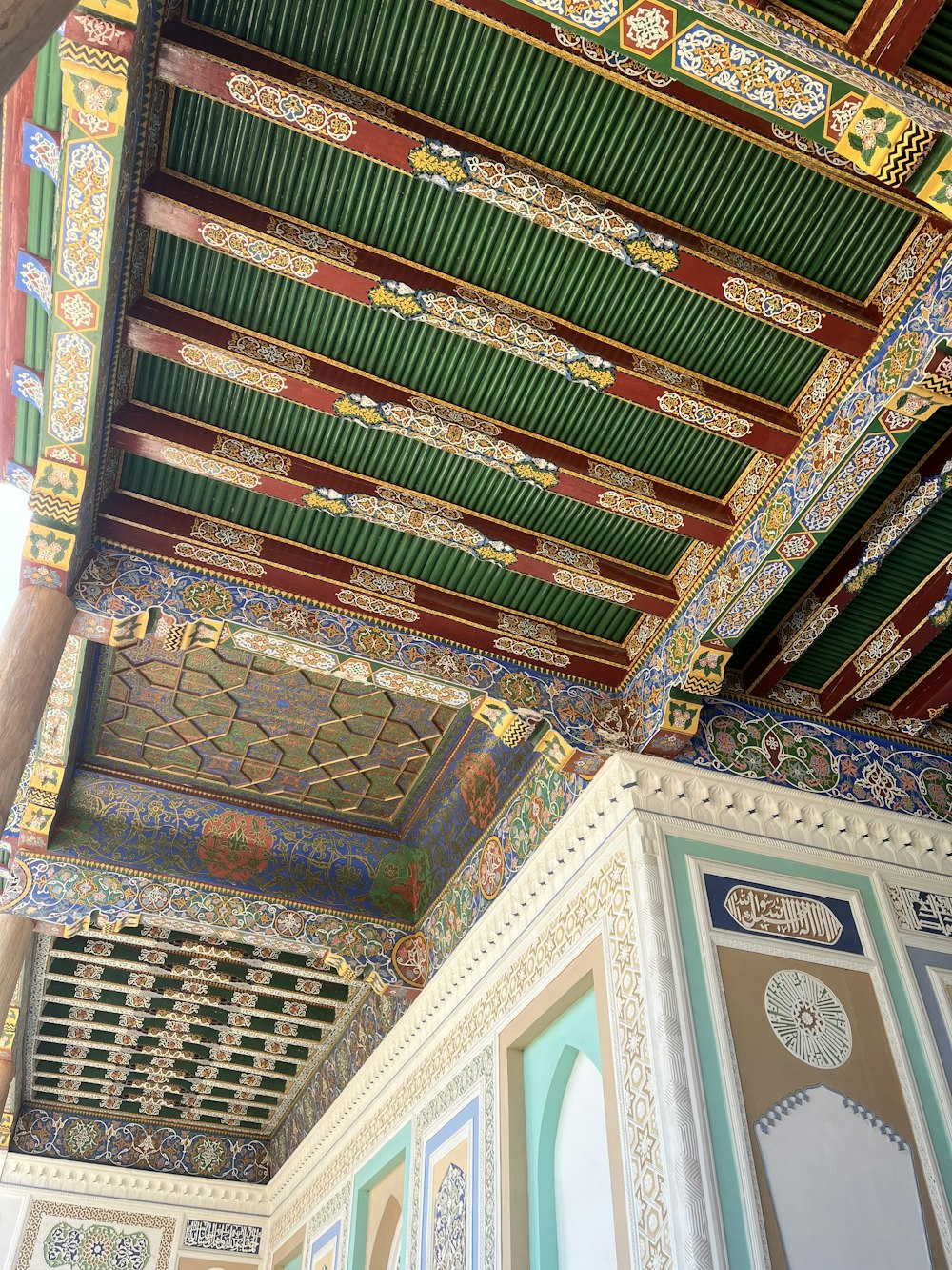the ceiling of a building with colorful designs on it