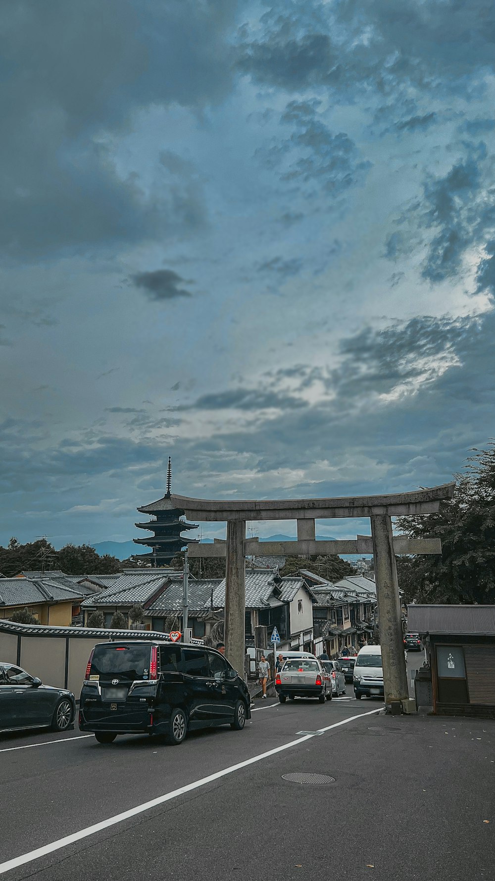 a large wooden arch over a street filled with cars