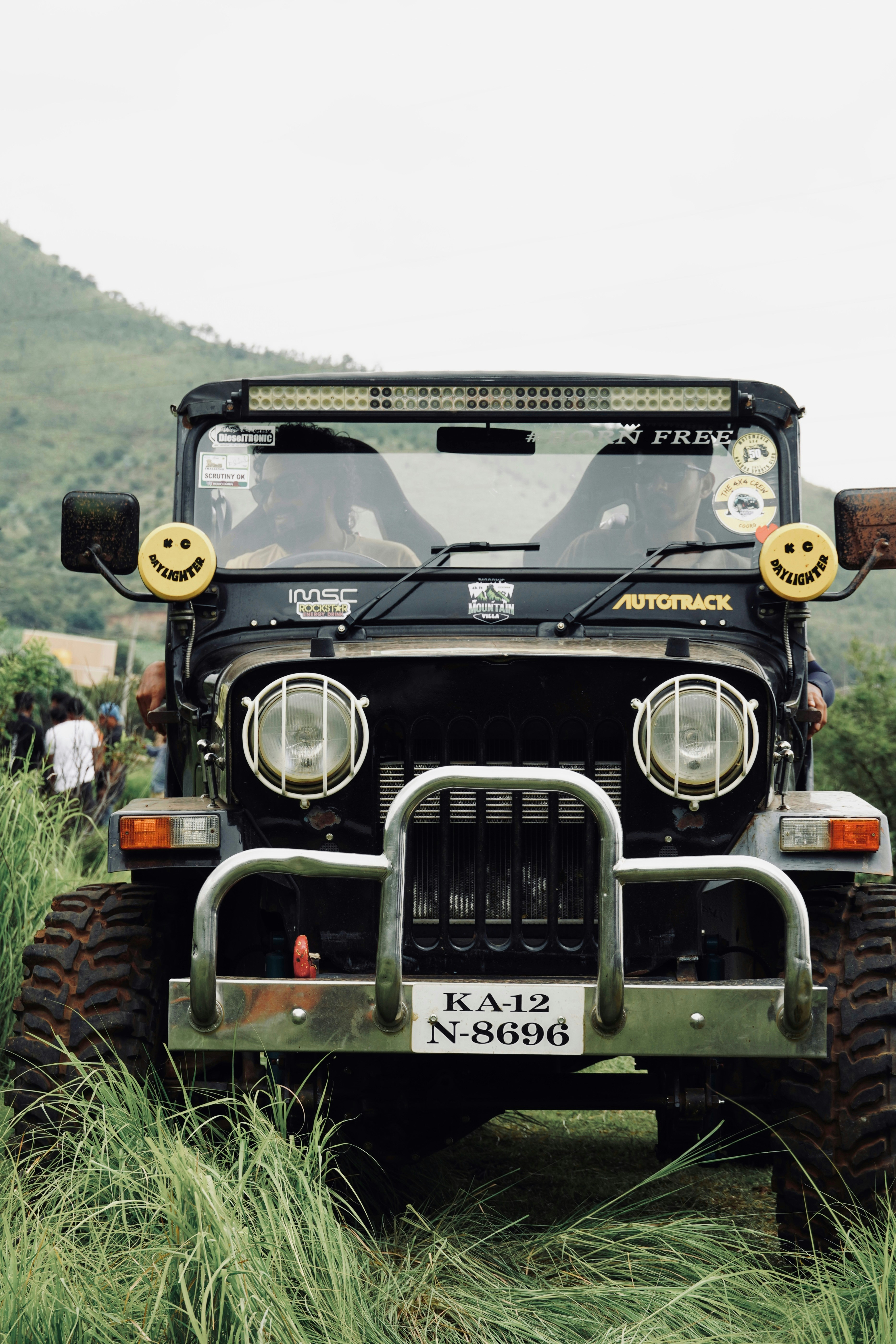 a jeep is parked in a field of tall grass