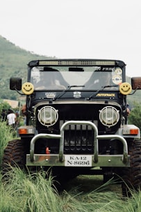 Local driver smiling next to a 4x4 jeep ready for adventure.