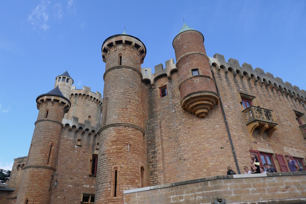 a large brick castle with a clock tower