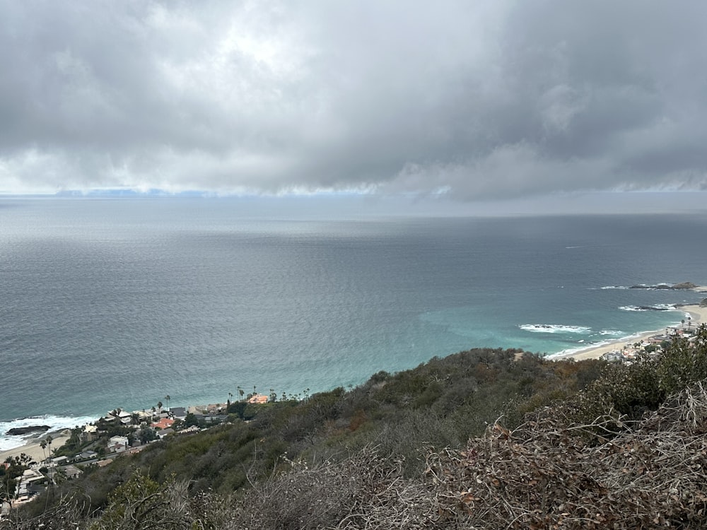 a view of the ocean from the top of a hill