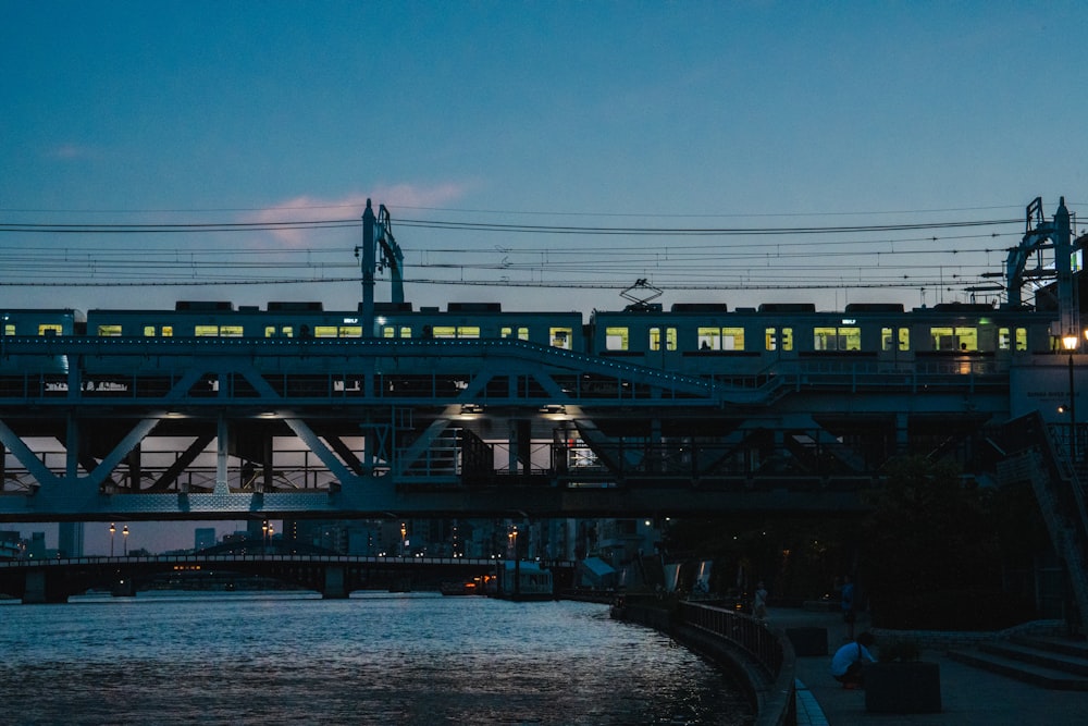 a train traveling over a bridge over a river