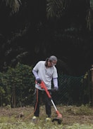 a man is using a lawn mower to cut grass
