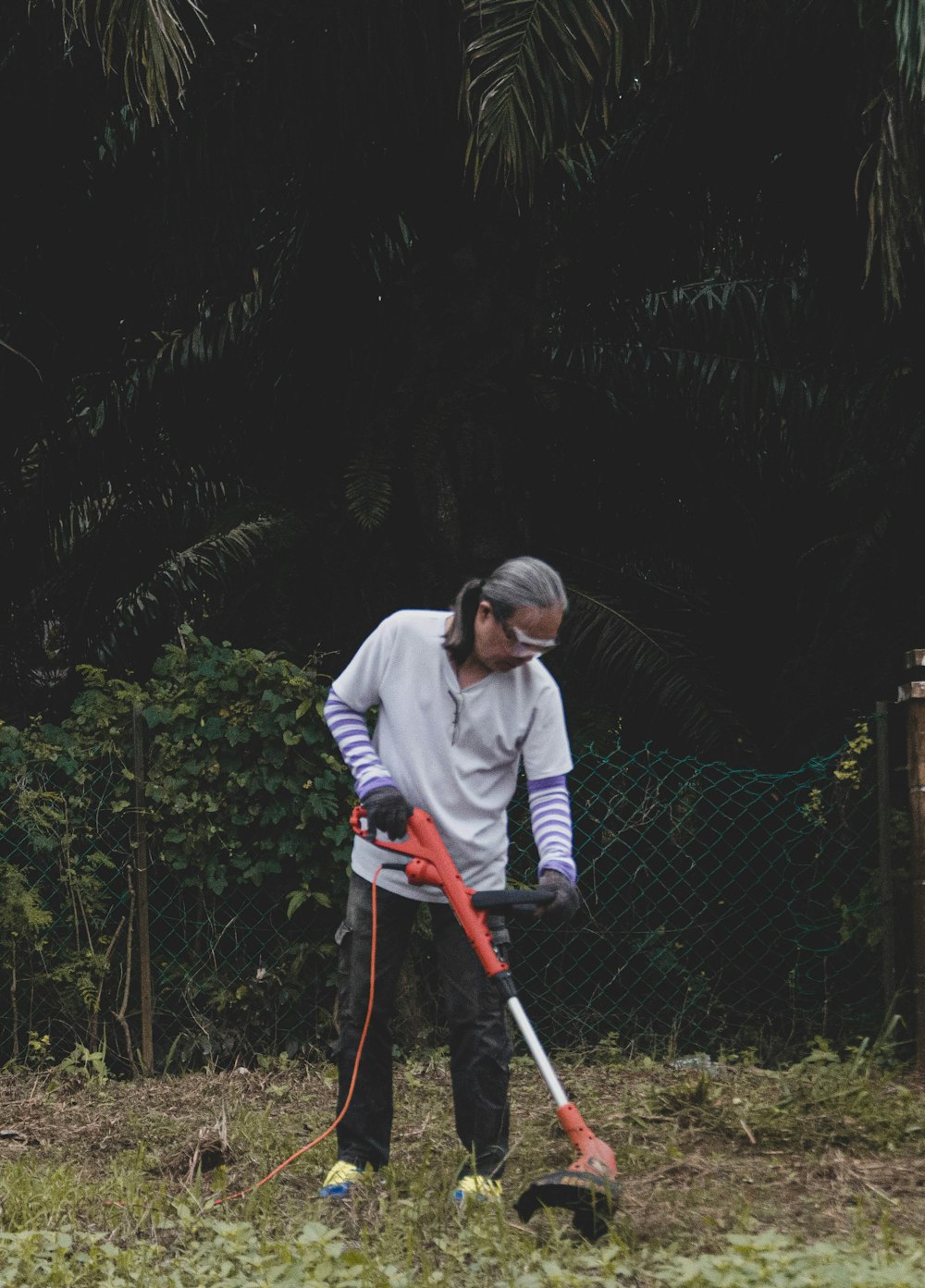 a man is using a lawn mower to cut grass