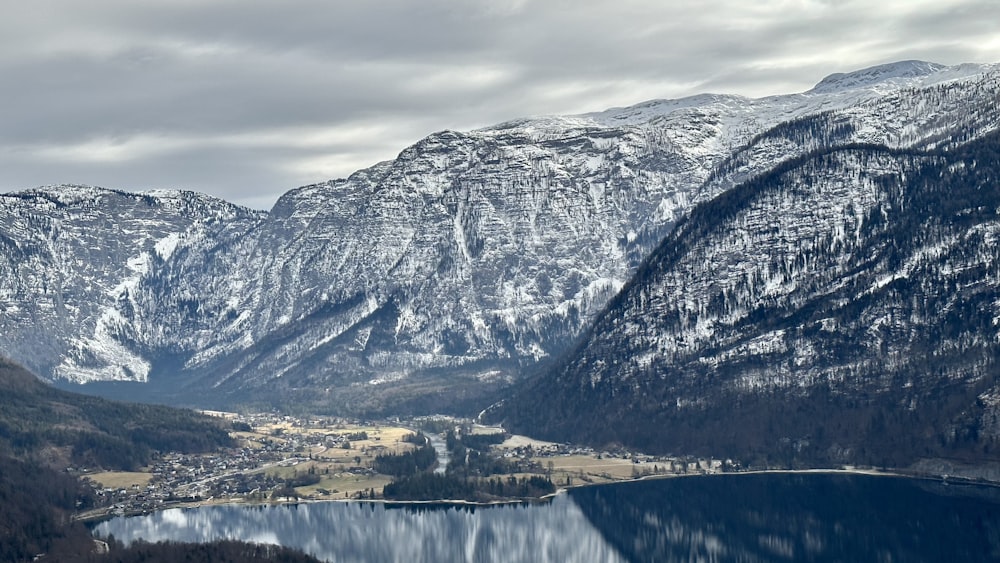 a view of a mountain range with a lake in the foreground