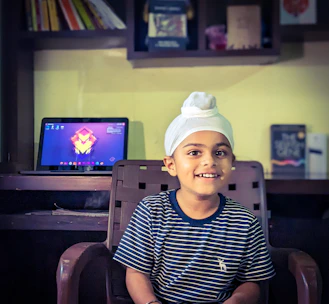 A cheerful student practicing Moroccan Darija on a laptop at home.