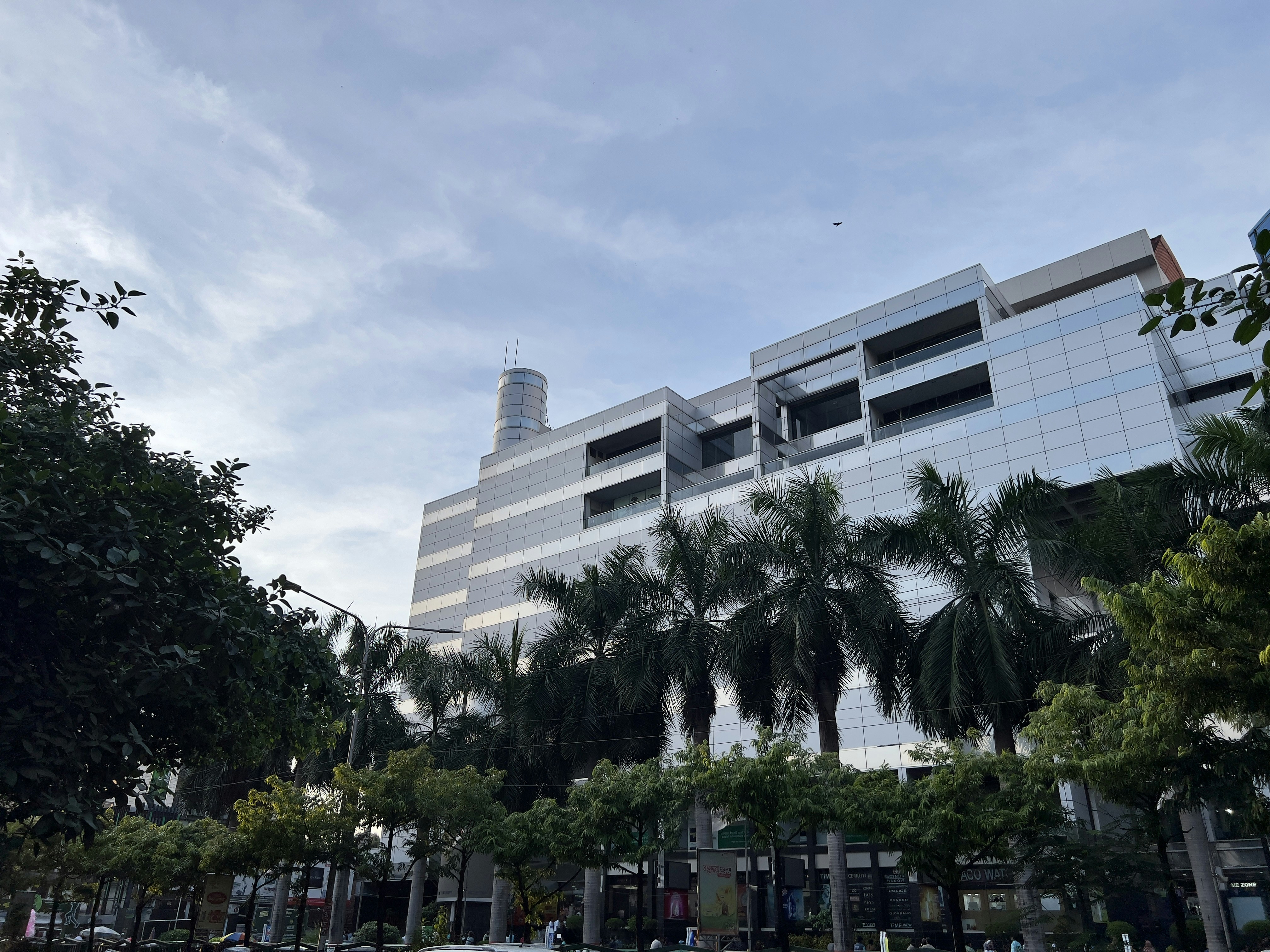 A large building with a lot of trees in front of it photo Free Bashundhara city shopping