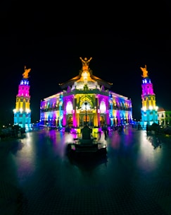 A stunning building illuminated with colorful projection mapping during a night show.