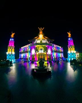 The Andhra Pradesh state assembly building illuminated at night.